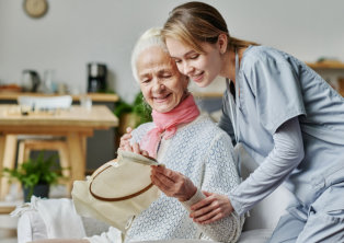 caregiver hugging senior