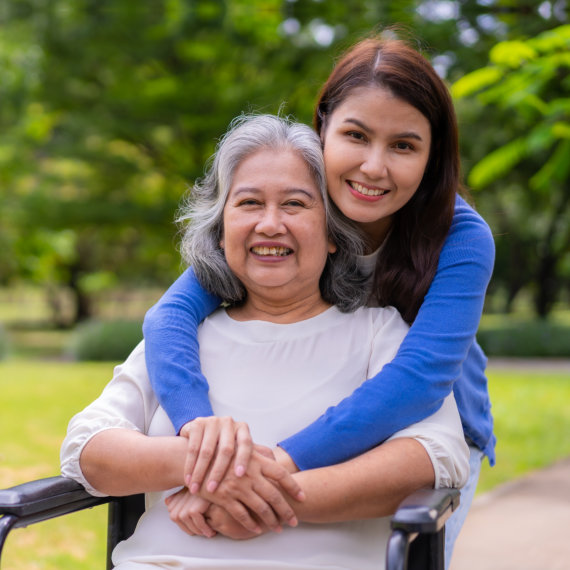 caregiver hugging senior