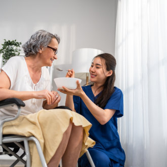 caregiver feeding senior