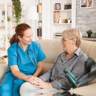 nurse talking to her patient senior