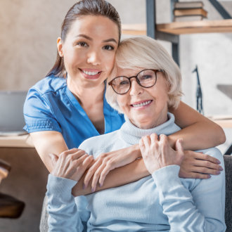 caregiver hugging senior