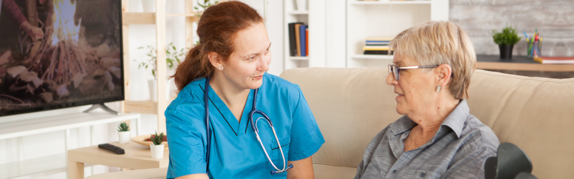 nurse talking to her patient senior