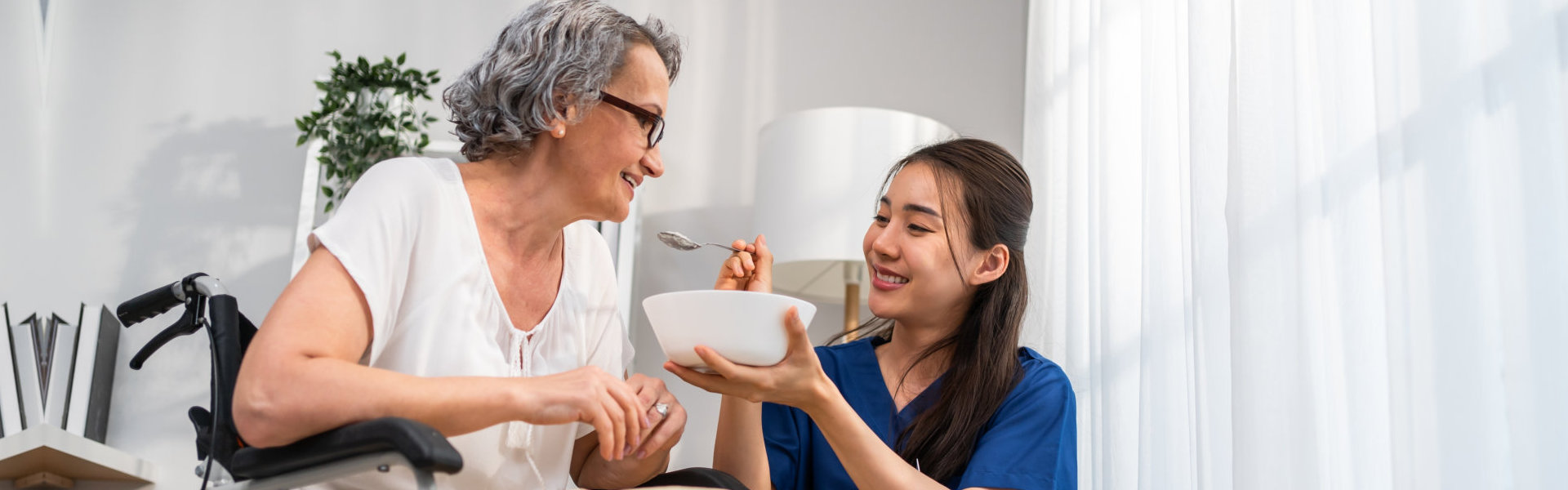 caregiver feeding senior